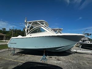 Sailfish 245 DC 2025 Sailfish 245 DC boat on stands in a parking lot.