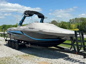 Centurion Fi25 2021 Centurion Fi25 boat on trailer, covered, parked on gravel with scenic background.