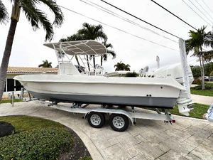 Twin Vee 26 Center Console 2013 Twin Vee 26 Center Console boat on trailer, parked near palm trees.