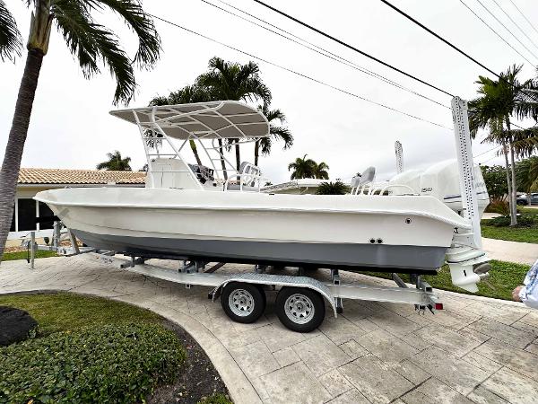 Twin Vee 26 Center Console 2013 Twin Vee 26 Center Console boat on trailer, parked near palm trees.