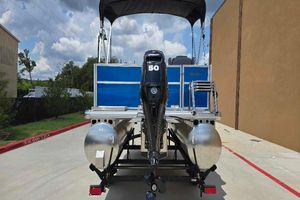 Sun Tracker Party Barge 16 DLX 2026 Sun Tracker Party Barge 16 DLX pontoon boat with 50 HP motor, rear view.