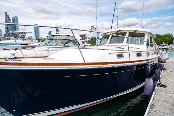 Sabre 48 Salon Express 2015 Sabre 48 Salon Express yacht docked in marina, city skyline in background.