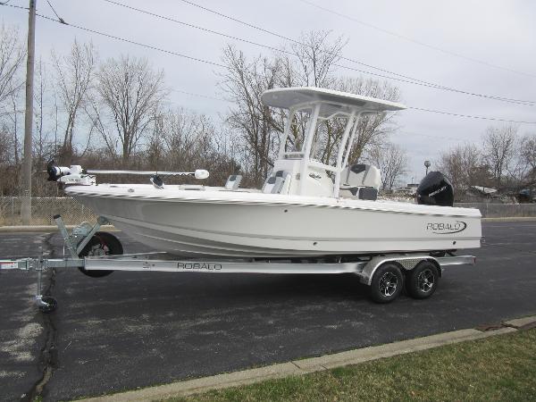 Robalo 226 Cayman 2024 Robalo 226 Cayman boat on a trailer in a parking lot.