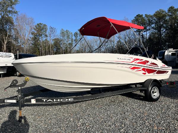 Tahoe T18 2022 Tahoe T18 boat with red canopy on trailer, parked outdoors.