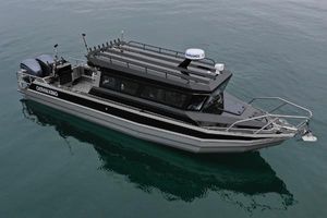 Custom Ocean King Custom Ocean King 2023 boat on calm water, featuring sleek design and modern equipment.