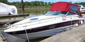 Crownline 255 CCR 2008 Crownline 255 CCR boat docked with red canopy, white hull, and scenic background.