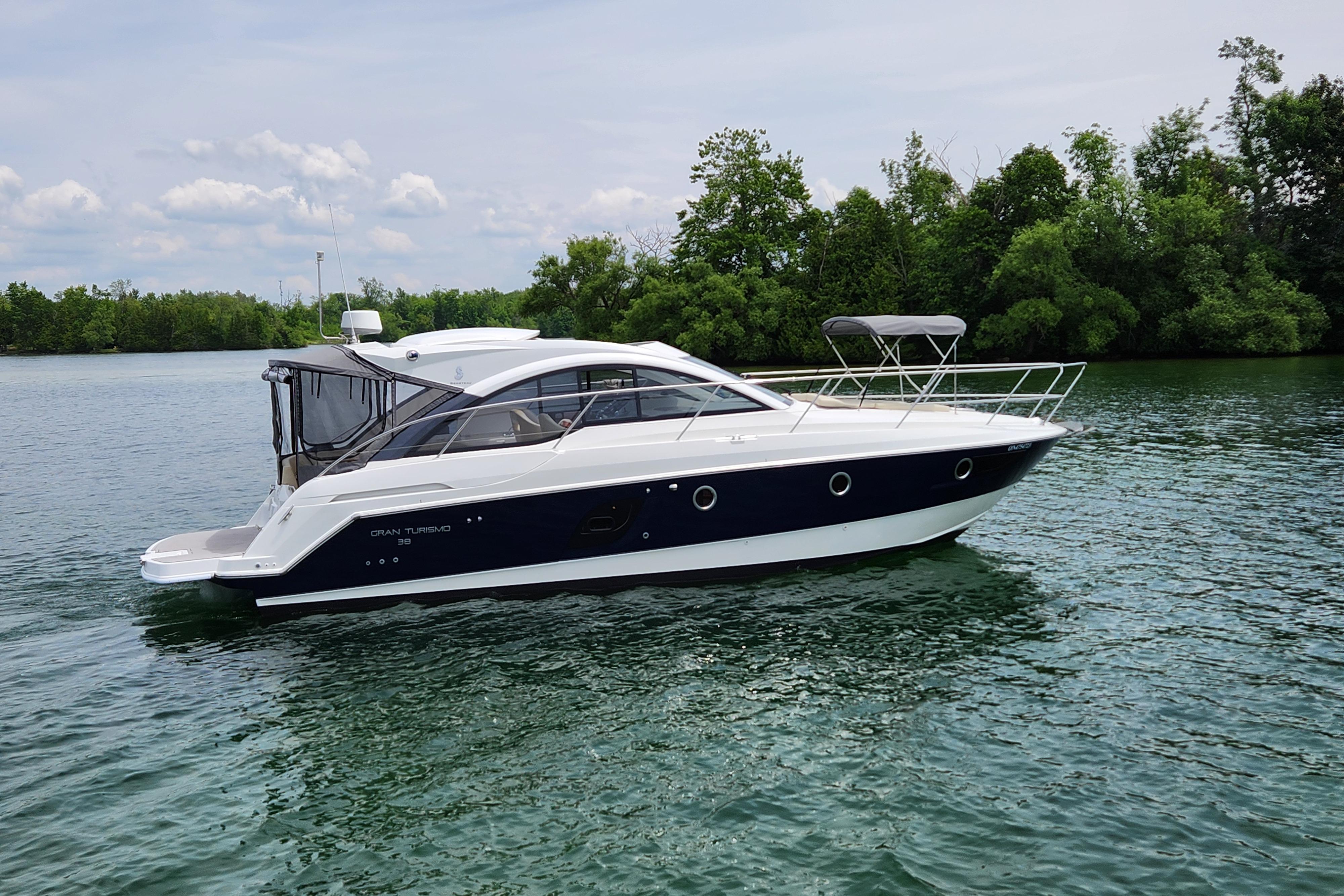 Beneteau GRAN TURISMO 38 2014 Beneteau GRAN TURISMO 38 yacht on calm water, surrounded by lush greenery.