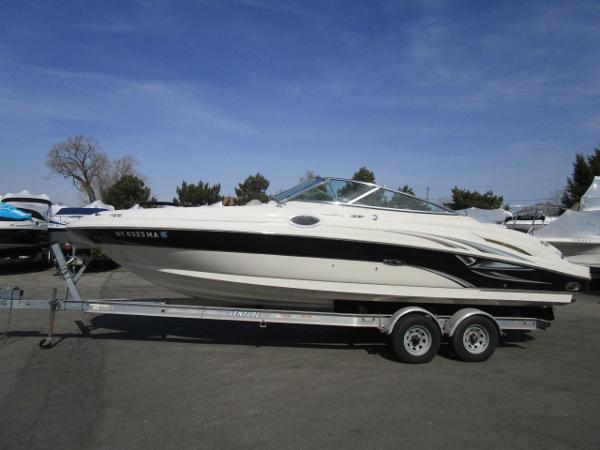 Sea Ray 270 Sundeck 2004 Sea Ray 270 Sundeck boat on trailer under clear blue sky.