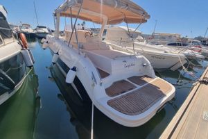 Mano Marine 25 Sport 2008 Mano Marine 25 Sport boat docked in marina, featuring spacious deck and canopy.