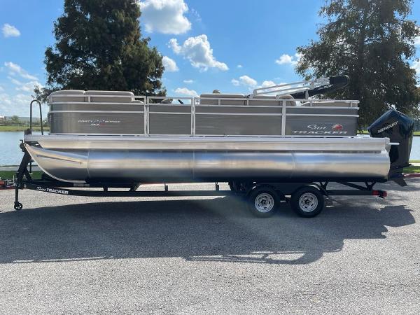 Sun Tracker Party Barge 22 RF XP3 2025 Sun Tracker Party Barge 22 RF XP3 pontoon boat on trailer, parked outdoors.