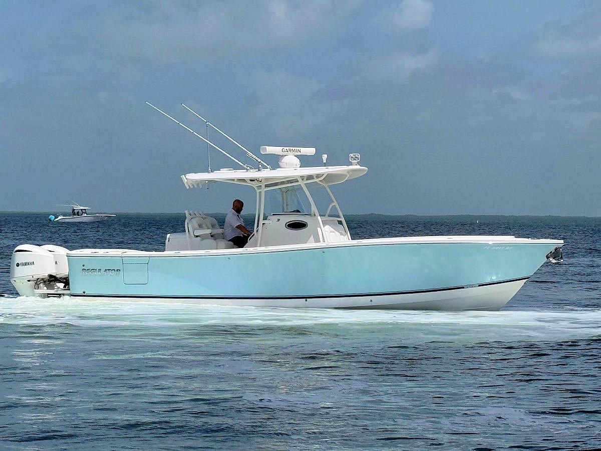 Regulator 31 2018 Regulator 31 boat cruising on open water with clear blue skies.