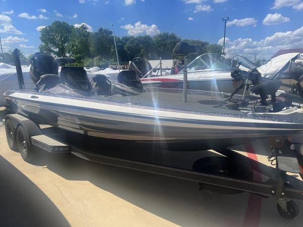 Skeeter ZXR 20 2021 Skeeter ZXR 20 bass boat on a trailer under a sunny sky.