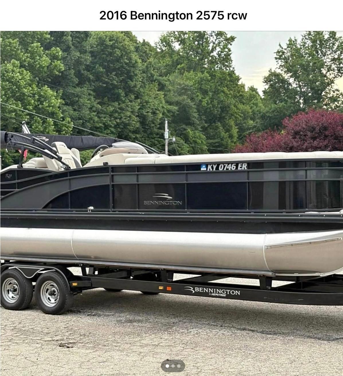Bennington 2575 RCW 2016 Bennington 2575 RCW pontoon boat on trailer, surrounded by lush greenery.