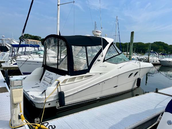 Sea Ray 310 Sundancer 2009 Sea Ray 310 Sundancer docked at marina, featuring sleek design and black canopy.