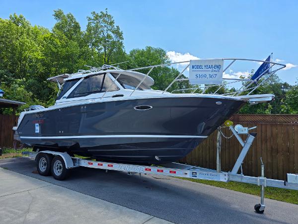 Cutwater C-248 Coupe 2024 Cutwater C-248 Coupe boat on trailer, displayed outdoors with price sign.