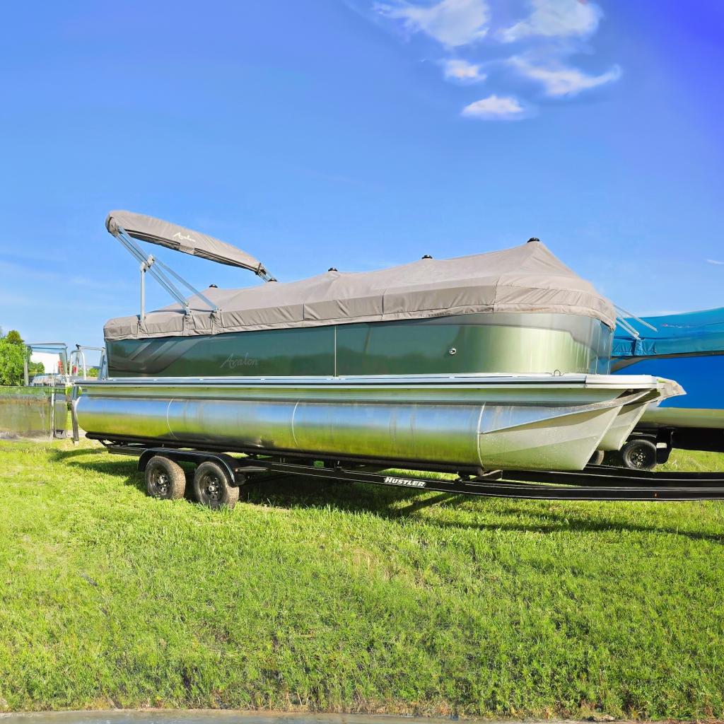 Avalon VLS Quad Lounge - 23' 2024 Avalon VLS Quad Lounge pontoon boat on trailer, covered and parked on grass.