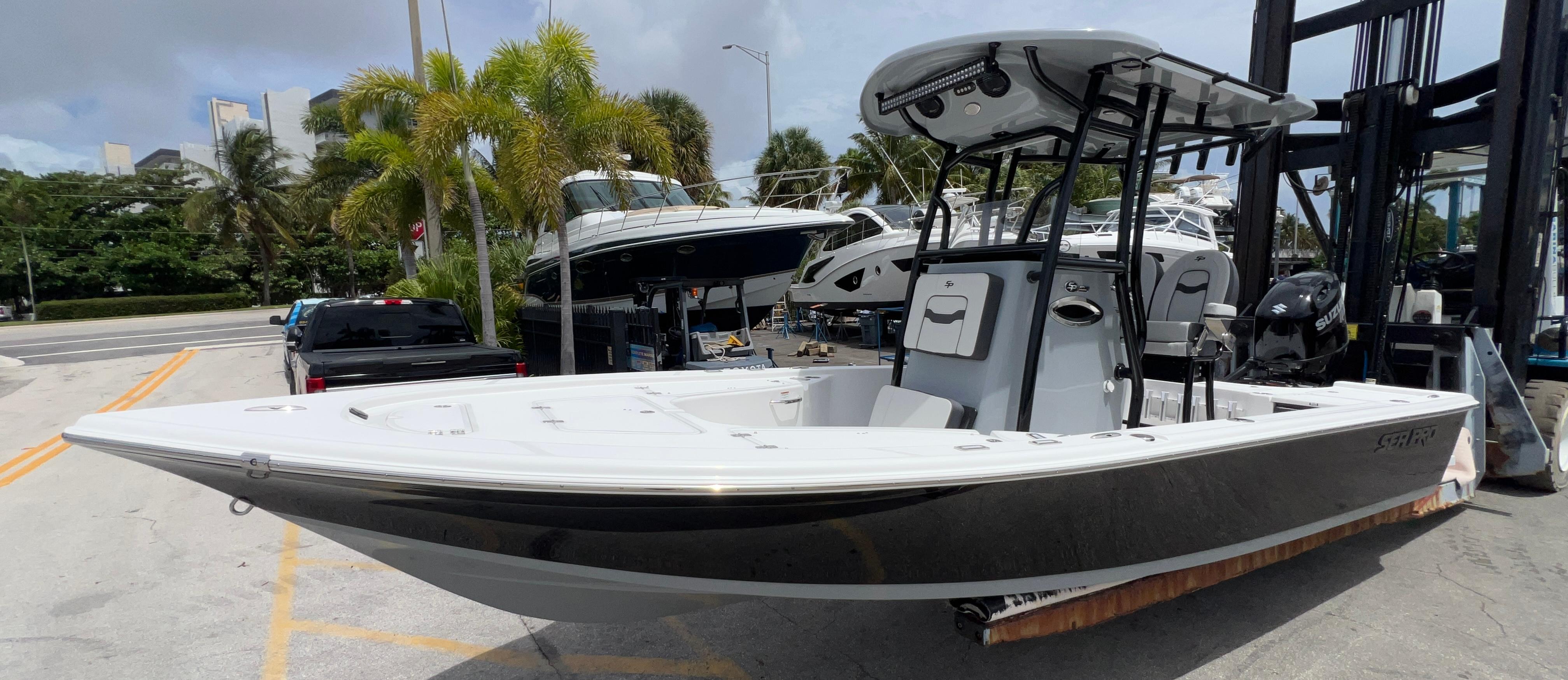Sea Pro 230 DLX 2026 Sea Pro 230 DLX boat displayed at a marina with palm trees.
