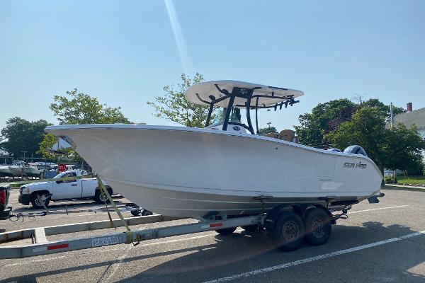Sea Pro 259 DLX 2023 Sea Pro 259 DLX boat on a trailer in a parking lot.