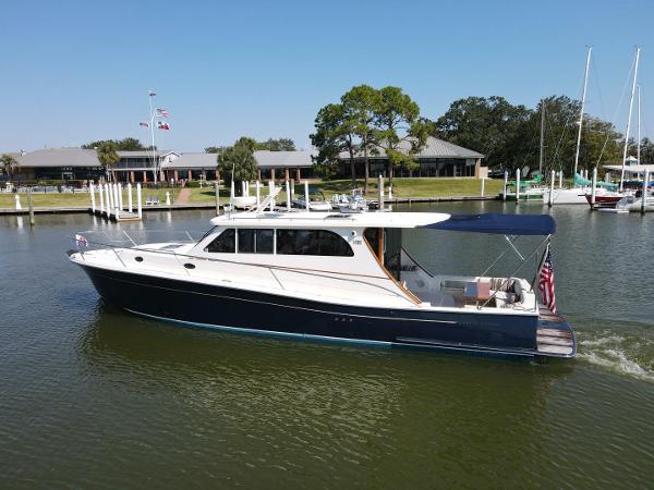 Rivolta Coupe 4.5 2008 Rivolta Coupe 4.5 yacht cruising on a calm river near a marina.