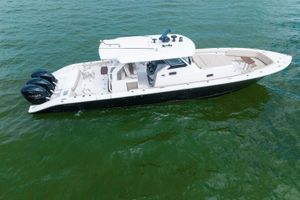 Pursuit 408 2019 Pursuit 408 boat with triple Yamaha engines on green water.