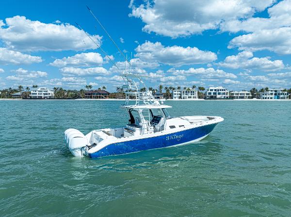 Edgewater 370CC 2023 Edgewater 370CC boat on calm water under a blue sky with clouds.