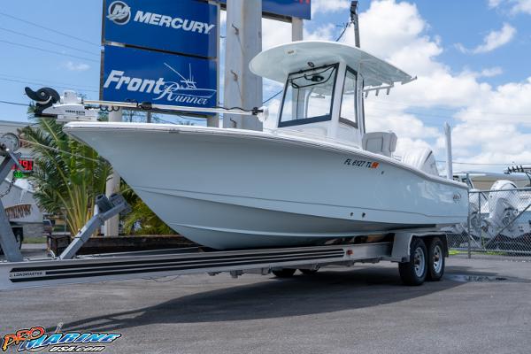 Sea Hunt BX 25 FS 2022 Sea Hunt BX 25 FS boat on trailer at dealership, clear sky background.