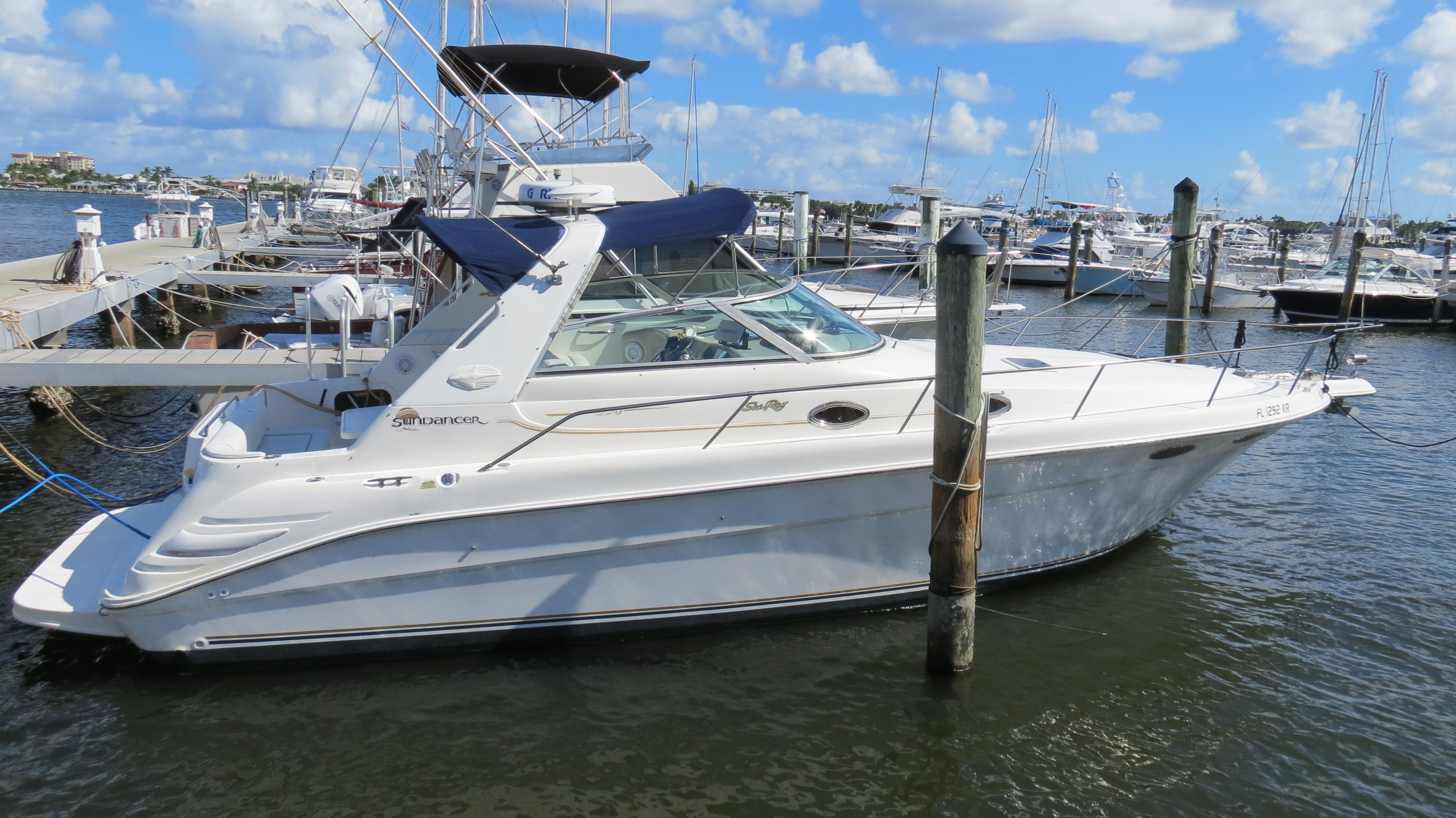 Sea Ray 330 Sundancer 1998 Sea Ray 330 Sundancer yacht docked at marina under blue sky.