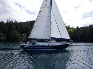 Pacific Seacraft 40 1998 Pacific Seacraft 40 sailboat cruising on a serene lake with forested background.