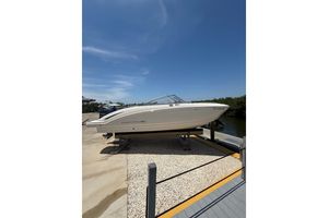 Chaparral 230 Suncoast 2016 Chaparral 230 Suncoast boat on lift under clear blue sky.