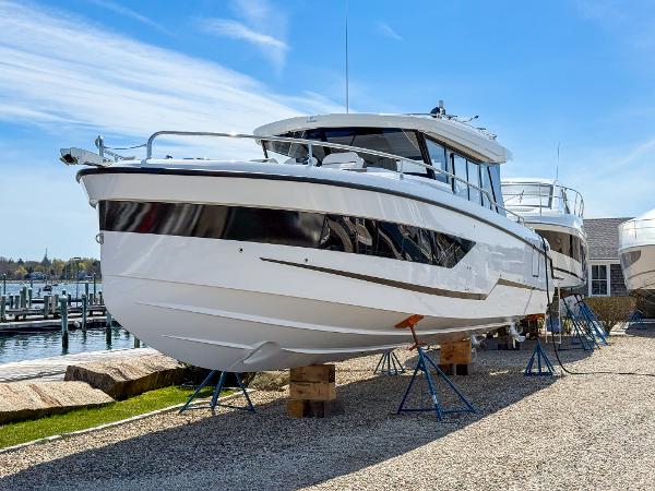 Wellcraft 38 Explorer 2025 Wellcraft 38 Explorer boat on stands, dockside, under clear blue sky.