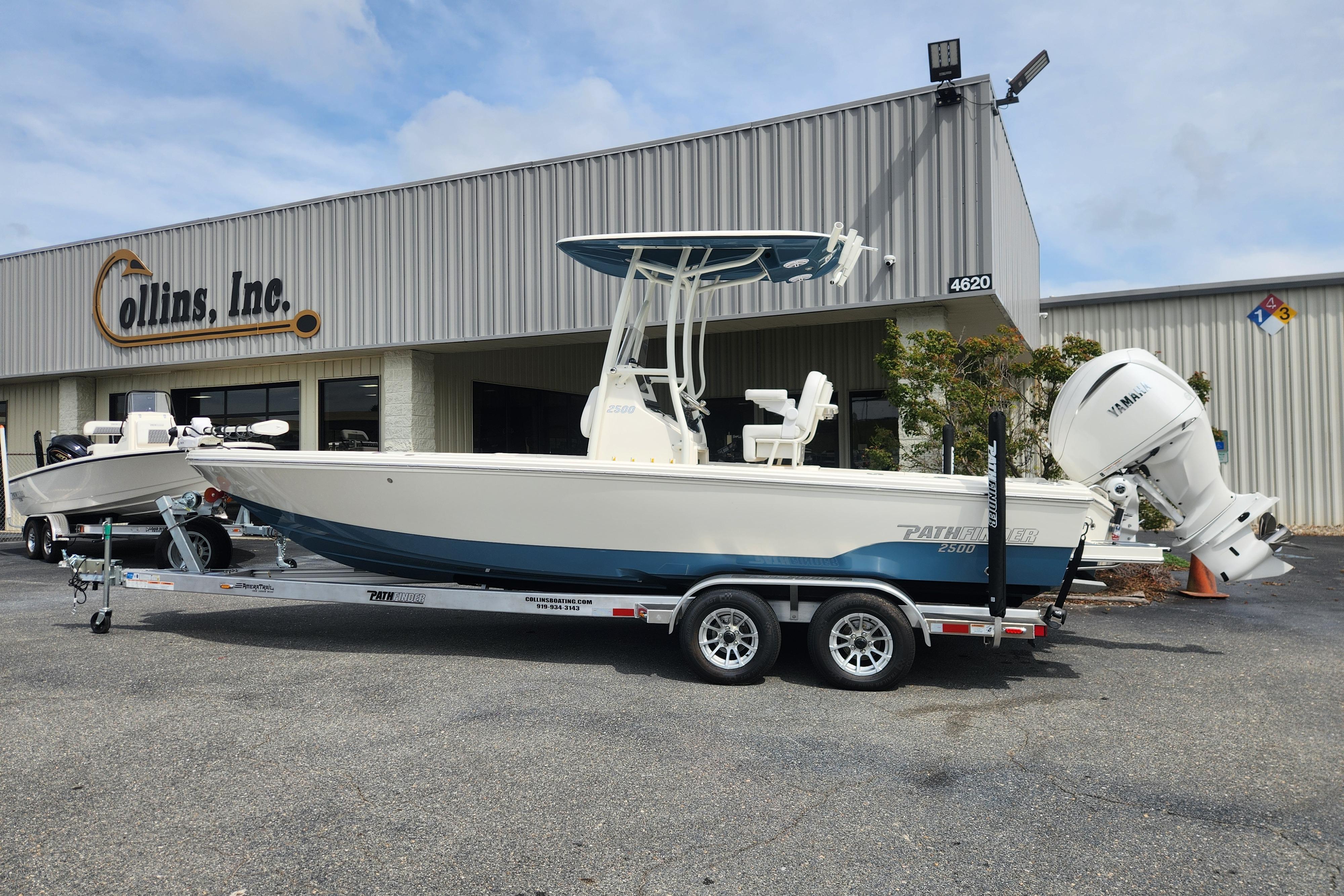 Pathfinder 2500 Hybrid 2025 Pathfinder 2500 Hybrid boat on trailer outside dealership.