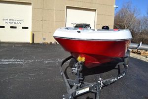 Tahoe T18 2025 Tahoe T18 boat on trailer, parked near maintenance building.
