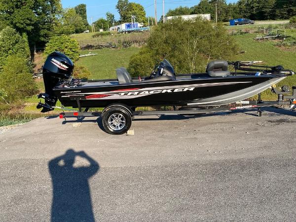 Tracker Pro Team 175 TF 2023 Tracker Pro Team 175 TF® fishing boat on a trailer in a rural setting.
