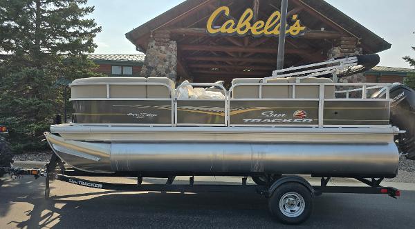 Sun Tracker Party Barge 18 DLX 2025 Sun Tracker Party Barge 18 DLX pontoon boat at Cabela's store.
