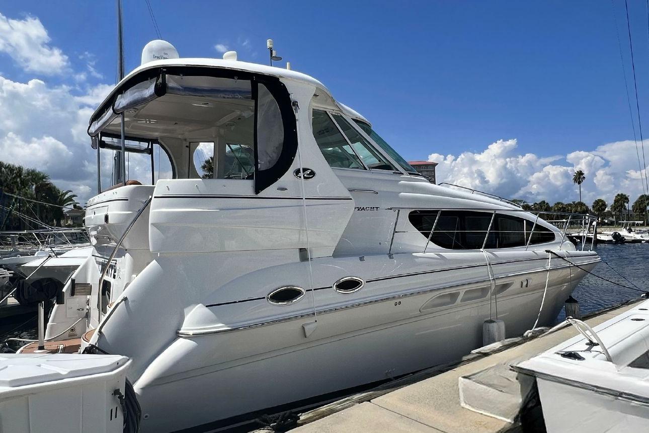 Sea Ray 390 Motor Yacht 2004 Sea Ray 390 Motor Yacht docked at marina under blue sky.
