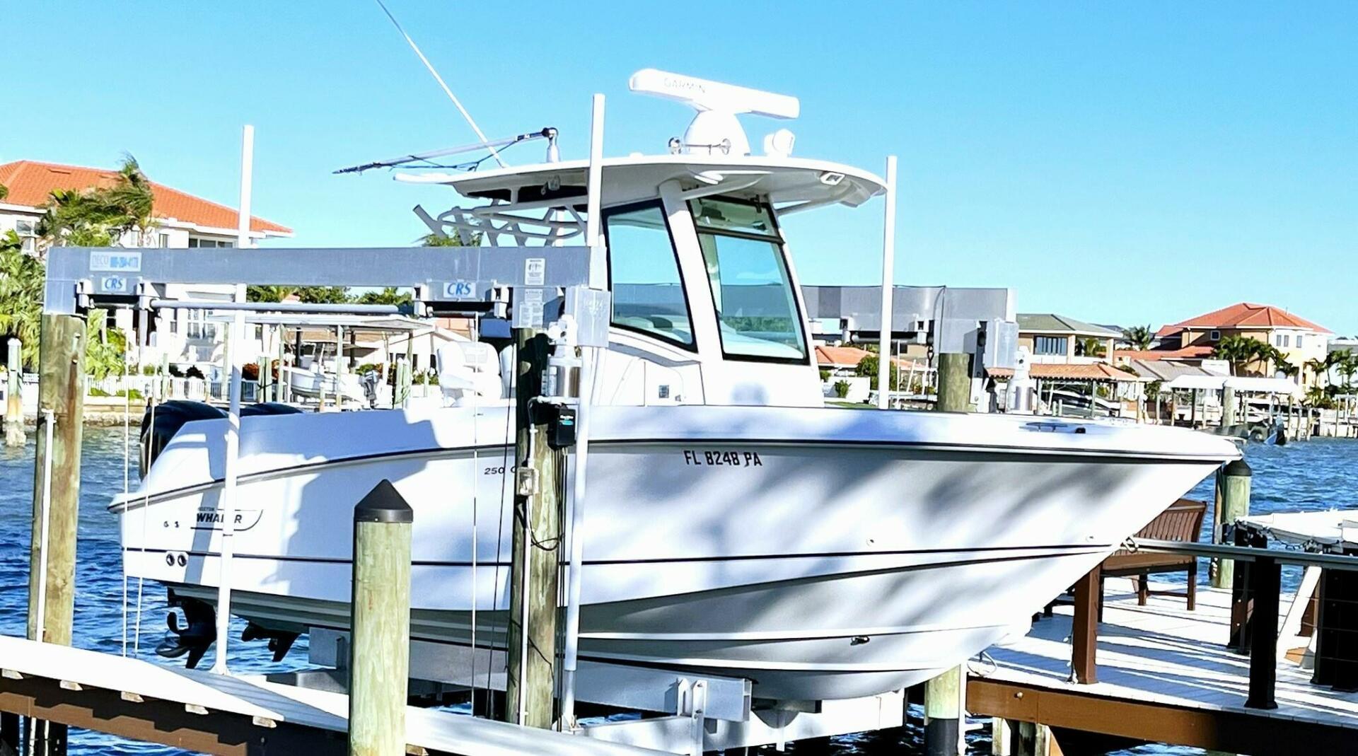 Boston Whaler 250 Outrage 2009 Boston Whaler 250 Outrage boat docked at a marina with waterfront homes.