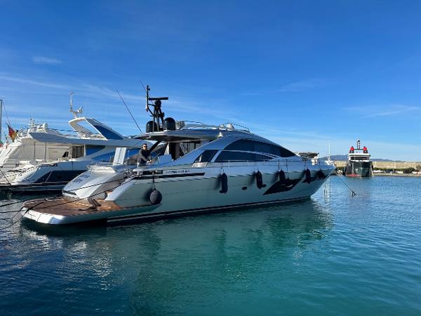 Pershing 8X Luxury Pershing 8X yacht, 2021 model, docked in a serene marina under clear blue skies.
