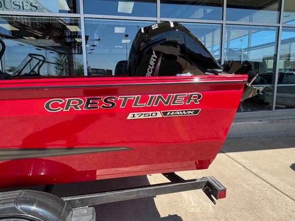 Crestliner 1750 Hawk Red 2025 Crestliner 1750 Hawk boat on trailer, displayed outdoors.