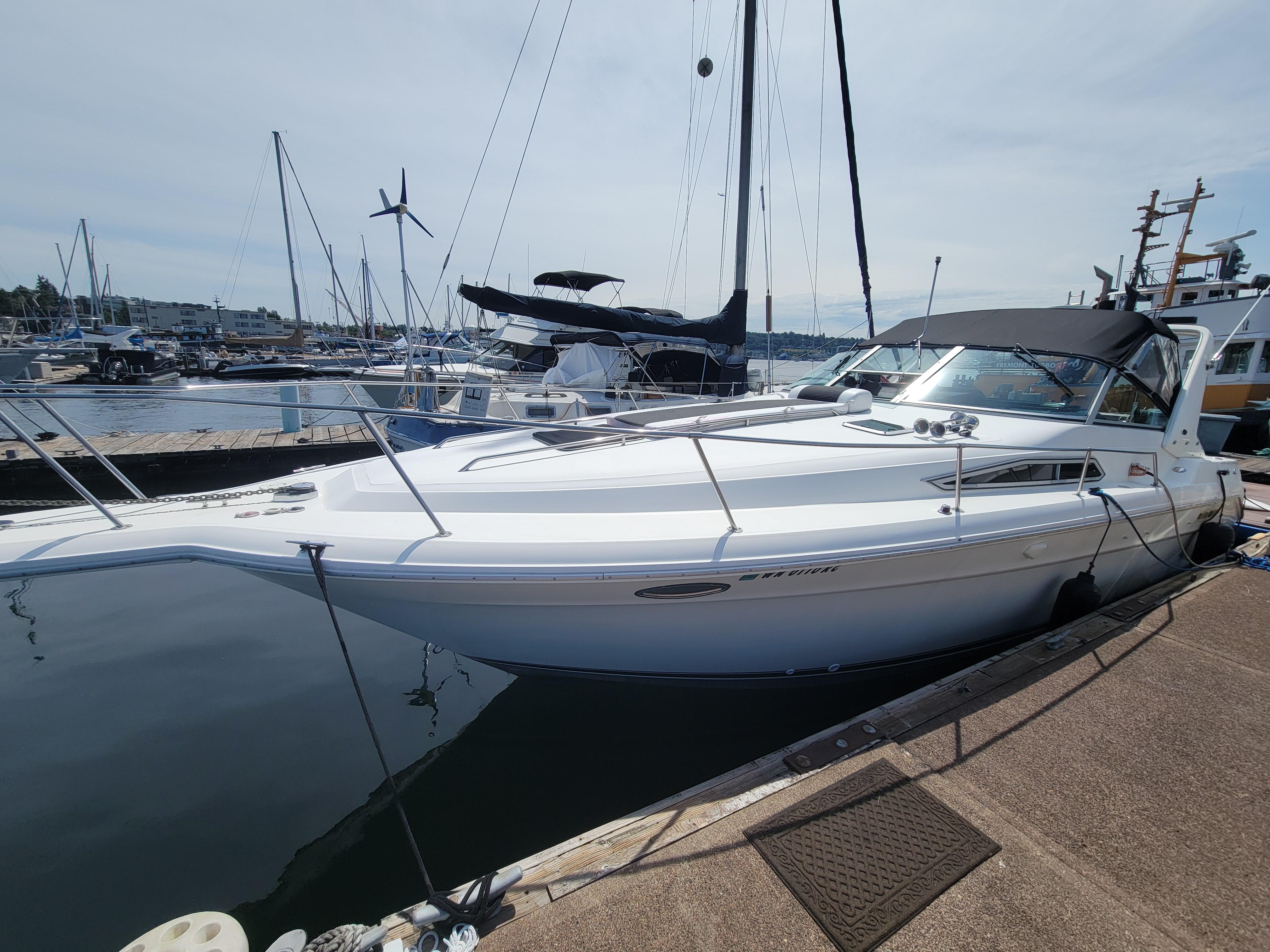 Sea Ray 330 Sundancer 1992 Sea Ray 330 Sundancer docked at marina, sleek white design, sunny day.