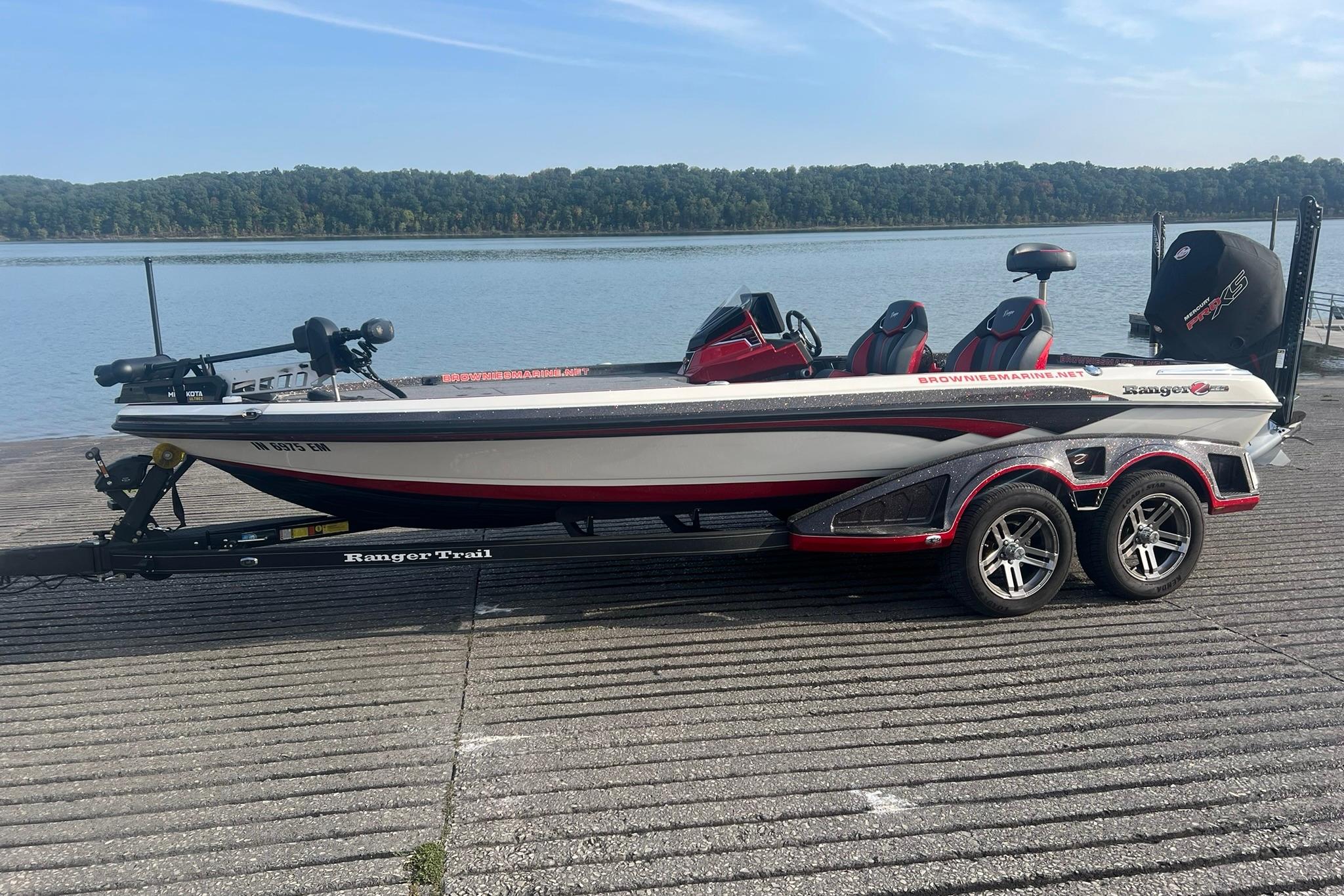 Ranger Z520R 2024 Ranger Z520R boat on trailer by a lake, featuring sleek design and dual seats.