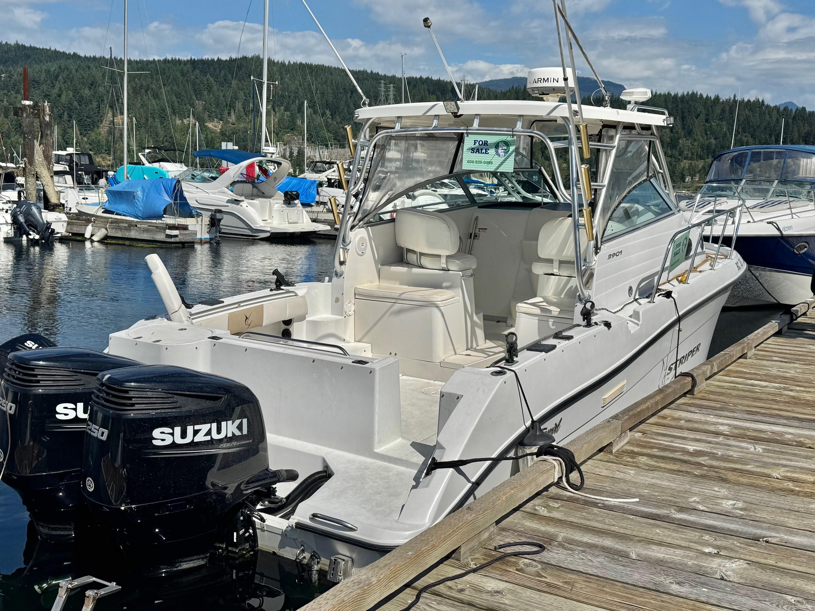 Striper 2901 Walkaround 2003 Striper 2901 Walkaround boat docked with twin Suzuki engines, for sale sign visible.