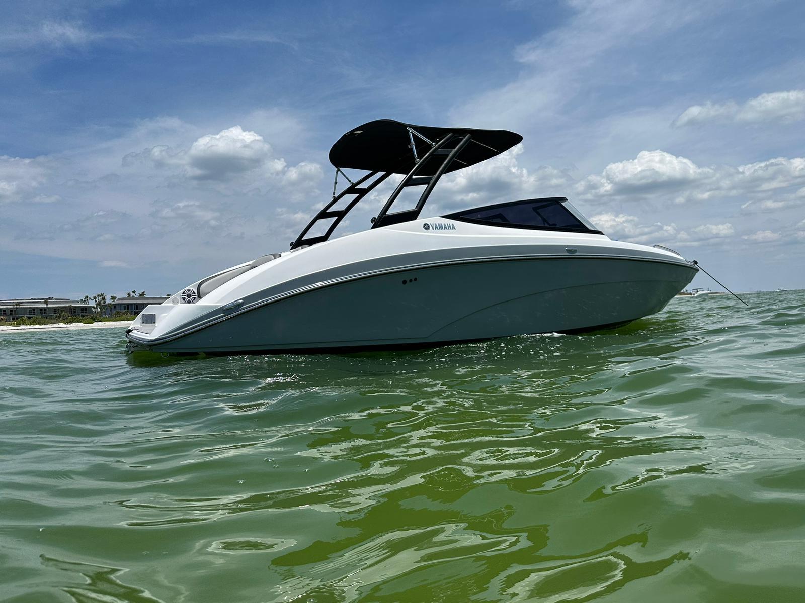 Yamaha Boats AR240 2020 Yamaha AR240 boat on calm green water under a partly cloudy sky.
