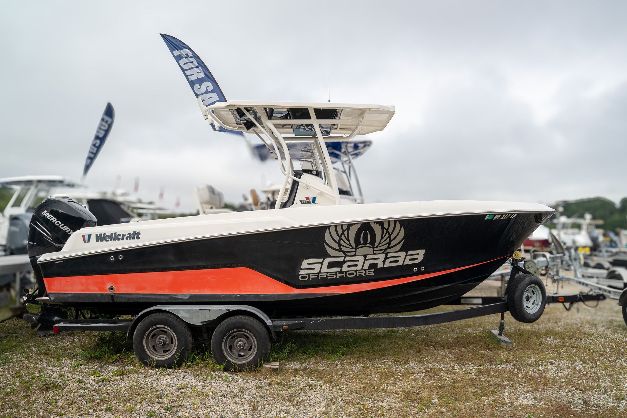 Wellcraft scarab 222 2017 Wellcraft Scarab 222 boat on trailer, displayed outdoors, with "For Sale" signs.