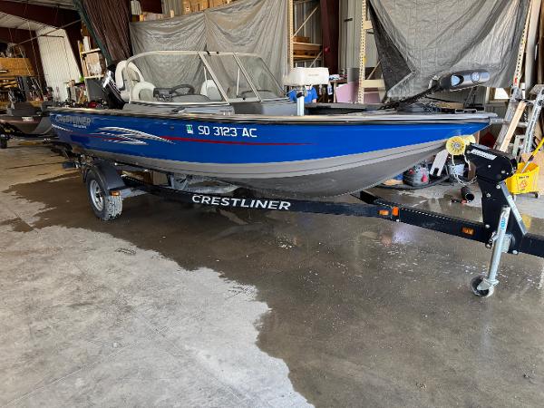 Crestliner 1850 Fish Hawk 2013 Crestliner 1850 Fish Hawk boat on trailer in a garage setting.