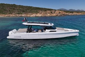 Axopar 45 Sun-Top 2024 Axopar 45 Sun-Top boat on clear blue water near rocky coastline.