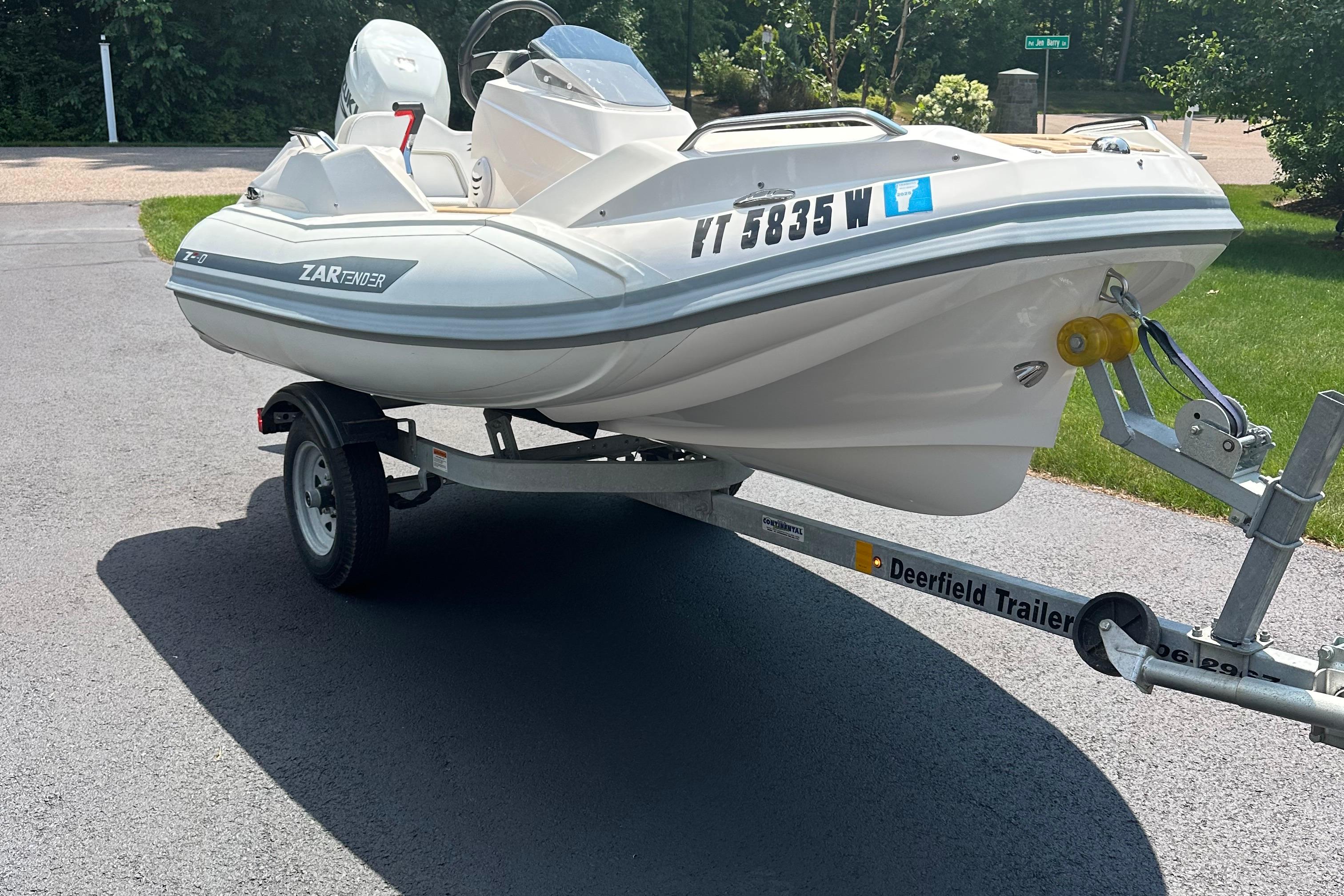Zar Tender - ZF0 2022 Zar Tender ZF0 boat on trailer, parked on driveway, ready for transport.