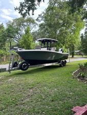 Blue Wave 2600 Makaira 2024 Blue Wave 2600 Makaira boat on trailer, parked on grassy area.