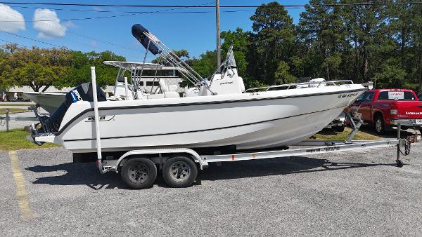 Boston Whaler 21 Outrage 2003 Boston Whaler 21 Outrage boat on trailer, parked outdoors.