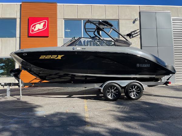 Yamaha Boats 222XD 2025 Yamaha Boats 222XD, sleek black design, on trailer outside dealership.