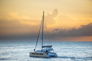 Aventura 45 S 2024 Aventura 45 S catamaran sailing at sunset on the ocean.